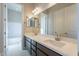 Double vanity bathroom with view into adjacent bedroom and tub at 266 S 165Th Ave, Goodyear, AZ 85338