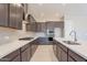 Modern kitchen with dark wood cabinets and a large island at 266 S 165Th Ave, Goodyear, AZ 85338