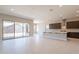 Modern kitchen with island, dark cabinetry, and sliding glass doors to backyard at 266 S 165Th Ave, Goodyear, AZ 85338