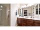 Bathroom with double vanity, large mirror, and glass shower door at 4413 N 24Th Pl, Phoenix, AZ 85016