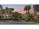 Attractive community entrance with lush landscaping at sunset at 4413 N 24Th Pl, Phoenix, AZ 85016