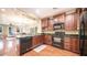 Open kitchen with island and dark wood cabinets at 4413 N 24Th Pl, Phoenix, AZ 85016