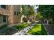 Community walkway with artificial turf and mature trees providing shade at 4413 N 24Th Pl, Phoenix, AZ 85016