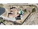 Aerial view of a home with a pool, fire pit, desert landscaping and solar panels at 19517 W Huron Ln, Buckeye, AZ 85326