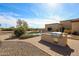 Backyard featuring a built-in grill and outdoor kitchen area adjacent to the pool at 19517 W Huron Ln, Buckeye, AZ 85326