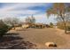 Expansive desert backyard showcasing the home's exterior and potential for landscaping at 19517 W Huron Ln, Buckeye, AZ 85326