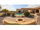 Backyard featuring a fire pit, paver patio, pool, and mature landscaping at 19517 W Huron Ln, Buckeye, AZ 85326