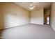 Spacious bedroom with ceiling fan and neutral carpet at 19517 W Huron Ln, Buckeye, AZ 85326