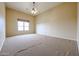 Bright bedroom with neutral carpet, ceiling fan, and window at 19517 W Huron Ln, Buckeye, AZ 85326