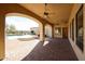 Large covered patio with brick pavers, ceiling fans, and a view of the pool and desert landscape at 19517 W Huron Ln, Buckeye, AZ 85326