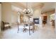 Elegant dining room with a fireplace, chandelier, and travertine floors at 19517 W Huron Ln, Buckeye, AZ 85326