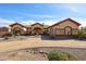 Elegant desert home showcasing stone accents, fountain, and manicured landscaping at 19517 W Huron Ln, Buckeye, AZ 85326