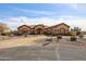 Charming desert home featuring a circular driveway, water feature, and natural desert landscape at 19517 W Huron Ln, Buckeye, AZ 85326