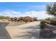 Wide view of the desert home exterior, highlighting the long driveway and three-car garage at 19517 W Huron Ln, Buckeye, AZ 85326