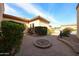 Well-manicured front courtyard with mature landscaping and a brick paver walkway at 19517 W Huron Ln, Buckeye, AZ 85326