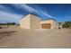 Spacious detached garage with a clean design and extended driveway at 19517 W Huron Ln, Buckeye, AZ 85326