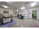 Spacious garage with epoxy floors, overhead storage, and a work bench area at 19517 W Huron Ln, Buckeye, AZ 85326