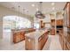 Spacious kitchen features double islands with granite countertops, wood cabinets, stainless steel appliances, and recessed lighting at 19517 W Huron Ln, Buckeye, AZ 85326