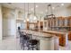 Open kitchen featuring marble floors, granite countertops, and stainless steel refrigerator at 19517 W Huron Ln, Buckeye, AZ 85326