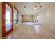 Bright living room with tile flooring, built-in shelving, and lots of natural light at 19517 W Huron Ln, Buckeye, AZ 85326