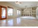 Bright living room featuring tile flooring, built-in shelving, and a large window at 19517 W Huron Ln, Buckeye, AZ 85326