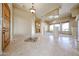 Spacious living room with travertine flooring, decorative tile inlay and natural lighting at 19517 W Huron Ln, Buckeye, AZ 85326