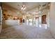 Large open living space with travertine floors, a fireplace, and custom ceiling details at 19517 W Huron Ln, Buckeye, AZ 85326