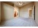 Expansive main bedroom with ceiling fan, neutral carpet, and en suite bathroom at 19517 W Huron Ln, Buckeye, AZ 85326