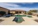 Backyard view showcasing a pool, hot tub, covered patio, and lush landscaping at 19517 W Huron Ln, Buckeye, AZ 85326