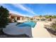 Exterior view of a beautiful backyard pool with mature landscaping on a sunny day at 19517 W Huron Ln, Buckeye, AZ 85326