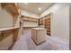 Spacious walk-in closet with custom shelving and storage island at 19517 W Huron Ln, Buckeye, AZ 85326