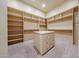 Large walk-in closet with custom shelving and a center island at 19517 W Huron Ln, Buckeye, AZ 85326