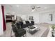 Stylish living room features neutral tones, a ceiling fan, and an open layout flowing into the kitchen and dining area at 2860 N Riverdale Ln, Casa Grande, AZ 85122