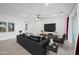 Well-lit living room featuring modern decor, tile flooring, and easy access to adjacent spaces at 2860 N Riverdale Ln, Casa Grande, AZ 85122