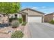 Charming single-story home featuring a well-maintained lawn and a two car garage at 532 W Tenia Trl, San Tan Valley, AZ 85140