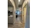 Clean hallway with laundry room and access to bedrooms at 532 W Tenia Trl, San Tan Valley, AZ 85140