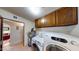 Laundry room with washer, dryer, and built-in shelving at 1007 N Revere --, Mesa, AZ 85201