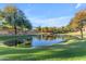 Scenic community pond with bridge and lush landscaping at 2067 W Periwinkle Way, Chandler, AZ 85248