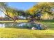 Peaceful community pond featuring a wooden footbridge and waterfall at 2067 W Periwinkle Way, Chandler, AZ 85248