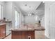 Kitchen island with granite countertop and wood cabinets at 2067 W Periwinkle Way, Chandler, AZ 85248