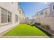 Green backyard with artificial grass, seating area, and gravel perimeter, creating a cozy outdoor retreat at 2200 N Iowa St, Chandler, AZ 85225