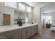 An ensuite bathroom featuring dual sinks, quartz countertops, and a luxurious walk-in shower at 2200 N Iowa St, Chandler, AZ 85225