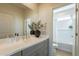 Stylish bathroom vanity with a modern sink, decorative mirror, and an adjacent water closet at 2200 N Iowa St, Chandler, AZ 85225