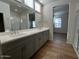 Double vanity bathroom with gray cabinets and quartz countertop at 2200 N Iowa St, Chandler, AZ 85225