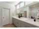 Modern bathroom with double vanity, large mirror, ample lighting, and a walk-in shower at 2200 N Iowa St, Chandler, AZ 85225