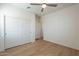 This bedroom features hardwood floors, a modern ceiling fan, and a closet, ideal for a minimalist design at 2200 N Iowa St, Chandler, AZ 85225