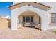 Inviting covered patio with comfortable seating and brick pavers, perfect for relaxing and enjoying the serene outdoor ambiance at 2200 N Iowa St, Chandler, AZ 85225