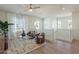 Bright living room with high ceilings, modern ceiling fan, neutral palette, and comfortable seating area at 2200 N Iowa St, Chandler, AZ 85225