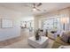 Spacious living room with a large window, neutral furniture, light wood floors, and a glimpse of the kitchen at 2200 N Iowa St, Chandler, AZ 85225