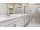 Bathroom features double sinks, white cabinets, and an adjacent walk-in shower at 5656 N 205Th Ln, Buckeye, AZ 85396